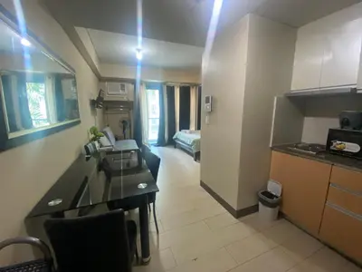 a room with a kitchen and a living room at two palm tree villas condotel by kath in Manila