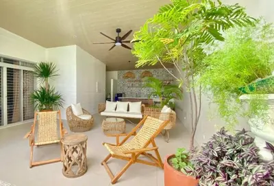 a living room with a couch and chairs and plants at Nazville vacation home in Pasig