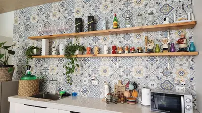 a kitchen with a counter with a tile wall at Nazville vacation home in Pasig