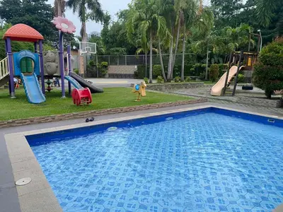 a swimming pool with a slide and a playground at Dym cozy condo pad in Manila