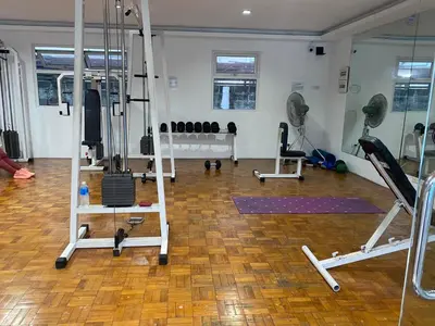 a gym with several treadmills and machines in a room at Dym cozy condo pad in Manila