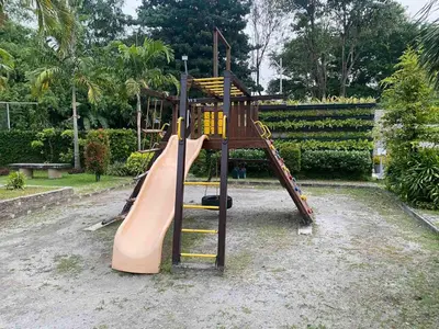 a playground with a slide in a park at Dym cozy condo pad in Manila