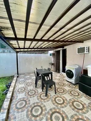 a patio with a table and chairs on a tile floor at Dym cozy condo pad in Manila
