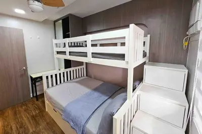 a bedroom with two bunk beds in a room at Stylish & Spacious Place Near BGC Fast Wi-Fi in Manila