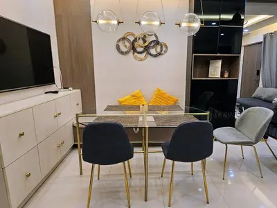 a dining room with a glass table and chairs at Stylish & Spacious Place Near BGC Fast Wi-Fi in Manila