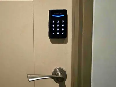 a door with a alarm clock on the door at Stylish & Spacious Place Near BGC Fast Wi-Fi in Manila