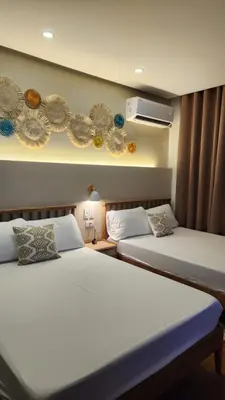 two beds in a room with two beds sidx sidx sidx at Nazville Vacation Home in Cainta