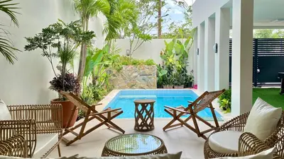 a patio with chairs and a swimming pool at Nazville Vacation Home in Cainta