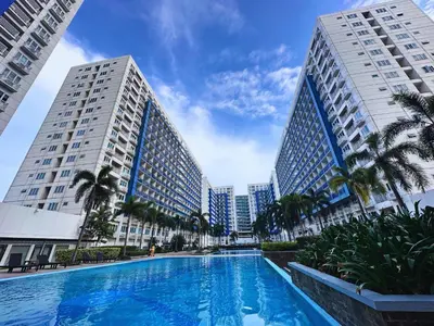 a swimming pool in front of two tall buildings at MSR Condo Vacation Rental in Manila