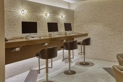 a room with three desks with two monitors and chairs at MADR Excellence at Novotel Manila Hotel Residence Acqua in Manila