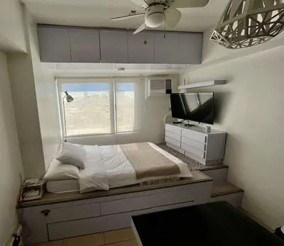 a bedroom with a large bed and a television at Avida Towers Intima Paco, Manila Studio Unit in Manila