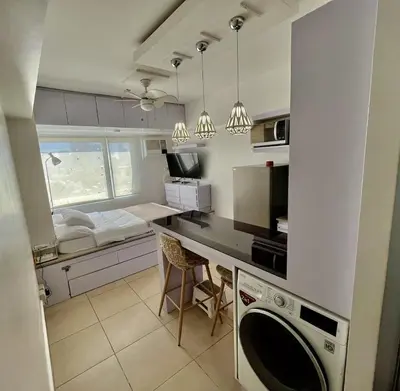 a kitchen with a washer and dryer in a room at Avida Towers Intima Paco, Manila Studio Unit in Manila