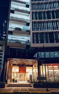 an external view of a building at night at Cozy Flat at Makati s Coolest St in Manila