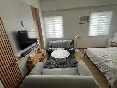 a living room with a couch and a table at Aras Solace Place in Trece Martires