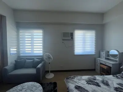 a living room with a couch and a bed and a tv at Aras Solace Place in Trece Martires