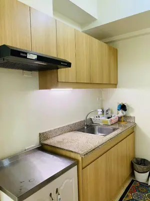 a kitchen with a sink and a counter top at timoncondotel city view in Manila
