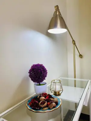 a table with a lamp and a plate of food on it at timoncondotel city view in Manila
