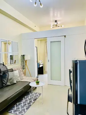 a living room with a couch and a table at SMDC Shore Residences in Manila