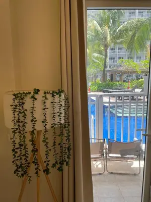 a room with a window with a plant at SMDC Shore Residences in Manila