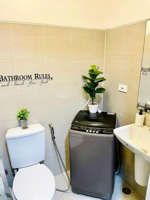 a bathroom with a toilet and a sink at SMDC Shore Residences in Manila