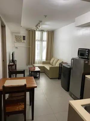 a living room with a couch and a table at The Serenity Tower 2610 in Manila