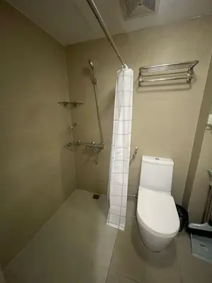 a bathroom with a toilet and a shower at The Serenity Tower 2610 in Manila