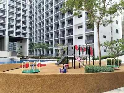 a playground in front of a large building at Bella Notte Staycation - SMDC Shore 2 MOA Complex in Manila