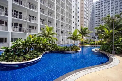 a swimming pool in front of a building at Bella Notte Staycation - SMDC Shore 2 MOA Complex in Manila