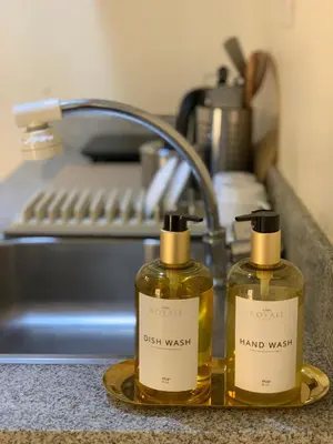 two bottles on a tray on a kitchen counter at CASA ROYALE Affordable Condo Near BGC Ortigas Center CBD in Manila