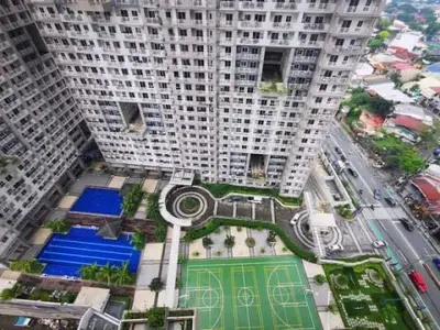 an overhead view of a tall building with a tennis court at CASA ROYALE Affordable Condo Near BGC Ortigas Center CBD in Manila
