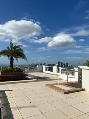 a view from the roof of a building with a palm tree at CASA ROYALE Affordable Condo Near BGC Ortigas Center CBD in Manila