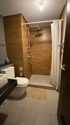 a bathroom with a toilet and a shower at The Radiance Manila Bay by Mary in Manila