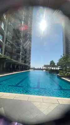 a large swimming pool in front of a tall building at The Radiance Manila Bay by Mary in Manila