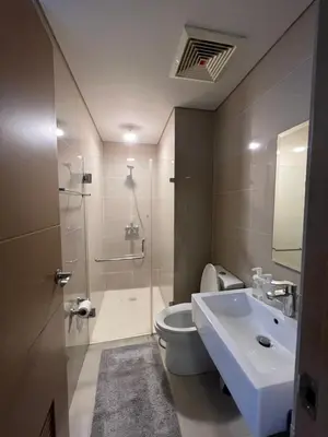 a bathroom with a toilet and a shower and a sink at Two Palm Tree Villas by Trisha in Manila