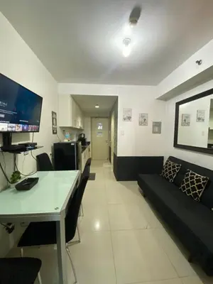a living room with a couch and a table at Bj's Staycation Manila - SEA Residences SM MOA in Manila