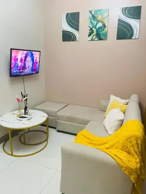 a living room with a couch and a table at BGC One Uptown Residences in Manila