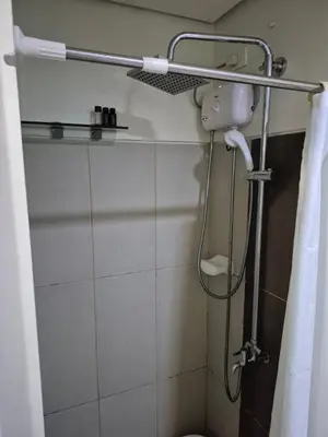 a shower in a bathroom with a shower head at Breeze Residences, Pasay City in Manila