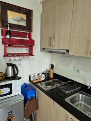 a small kitchen with a sink and a stove at Breeze Residences, Pasay City in Manila