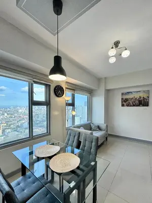 a living room with a couch and a table at Cozy 1BR Condo in Manila Near US Embassy and Robinsons Place Manila in Manila