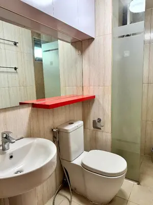 a bathroom with a white toilet and a sink at Cozy 1BR Condo in Manila Near US Embassy and Robinsons Place Manila in Manila