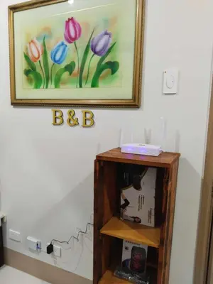a picture of flowers on a wall with a shelf at The Chill Spot Residences Property Management in Manila