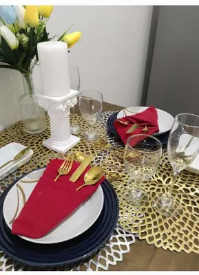 a table with red napkins and plates and wine glasses at The Chill Spot Residences Property Management in Manila