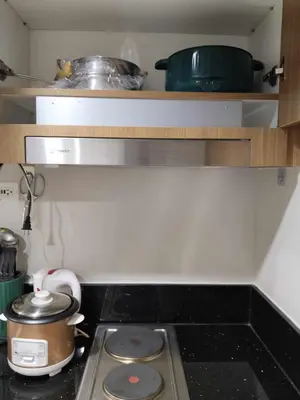 a kitchen counter with a stove and some pots and pans at The Chill Spot Residences Property Management in Manila