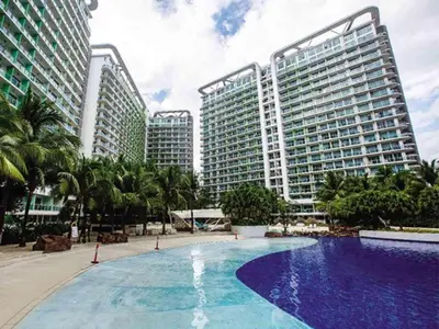 a large swimming pool in front of two tall buildings at Premium 1Bedroom Condo Unit Near Airport, MOA, Casinos, SM Bicutan in Manila