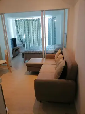 a living room with a couch and a bed at Premium 1Bedroom Condo Unit Near Airport, MOA, Casinos, SM Bicutan in Manila