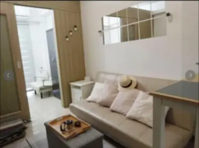 a living room with a couch and a table at My Serenity Suite in Manila