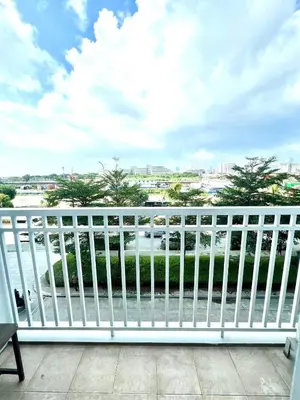 a white railing on a balcony with a view of the water at My Serenity Suite in Manila