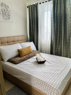 a bed with two pillows and a blanket on it at Serenitude Staycation by Khaila - Fame Residences in Manila