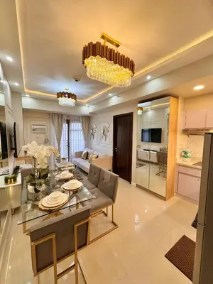 a kitchen and living room with a table and chairs at Manila Bay Suite in Manila