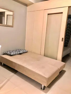 a bed sitting in a room with at Cosy Light Residences Unit Staycation in Manila